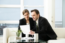 two professional people reviewing documents