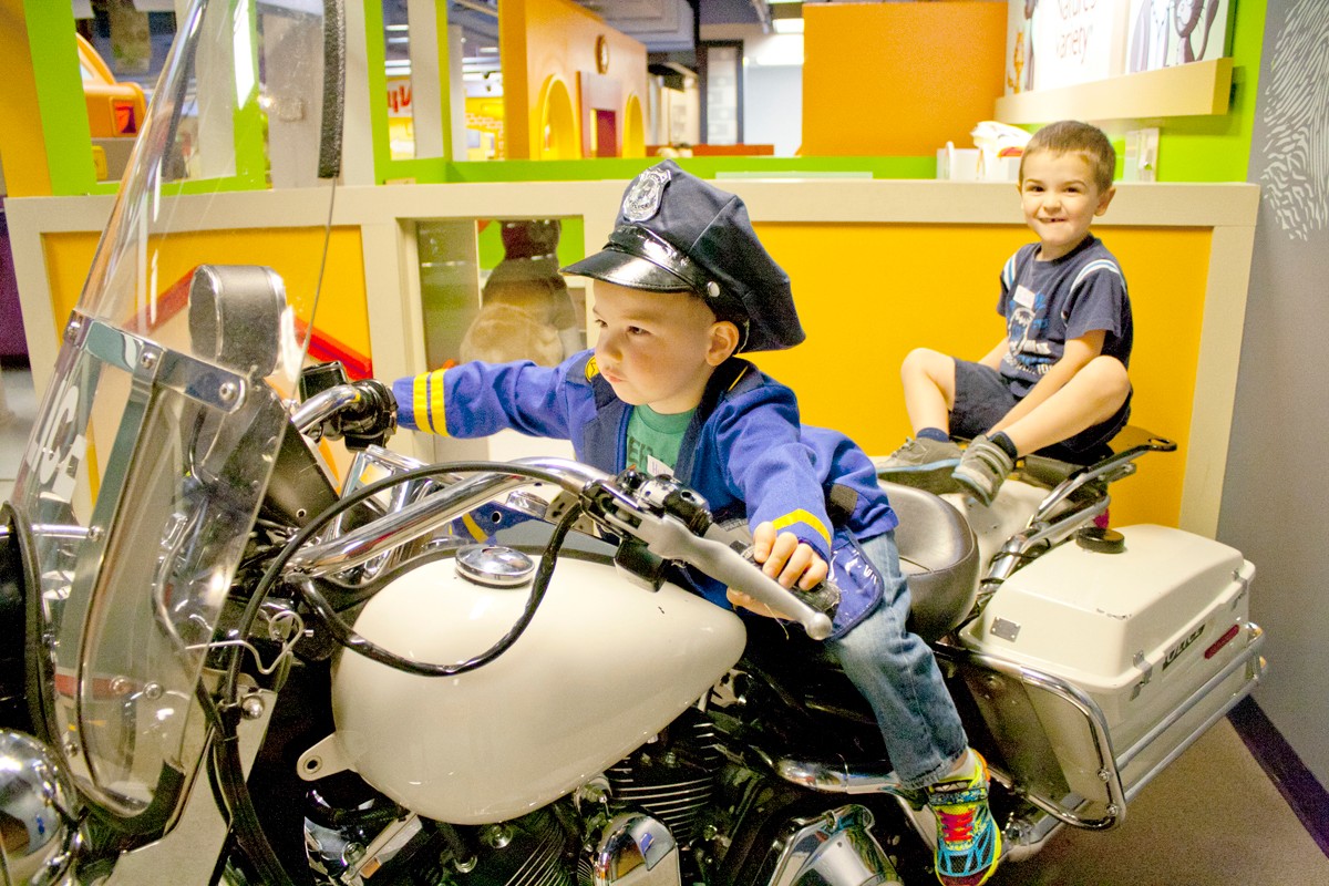 Kids dressed as police officers on motorcycle