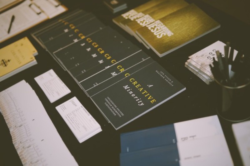 marketing brochures and business cards laid out on a table