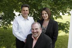Jerry Velona, Dave Theriault (seated) and Tracie Theriault - founders of Elite Envelope & Graphics, Inc.