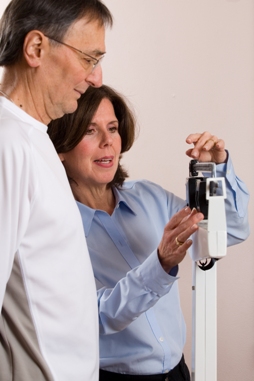 A photo of dietitian weighing a client on a scale
