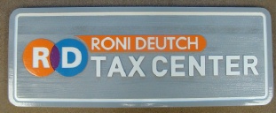 Sandblasted wooden Tax Center sign.