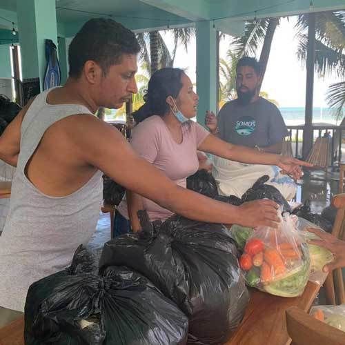 People handing out fresh produce.