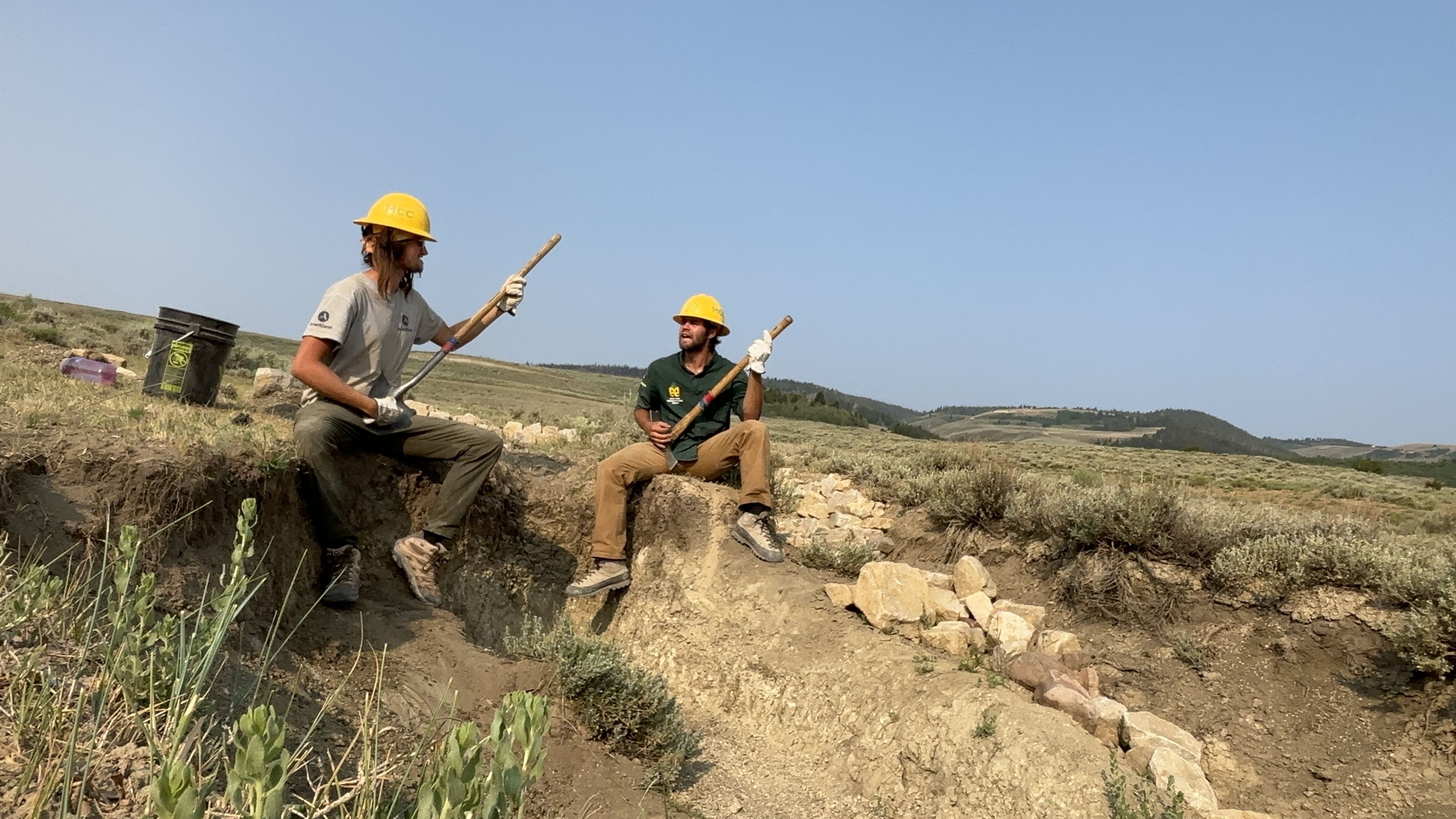 Two crew members play electric guitar with their tools