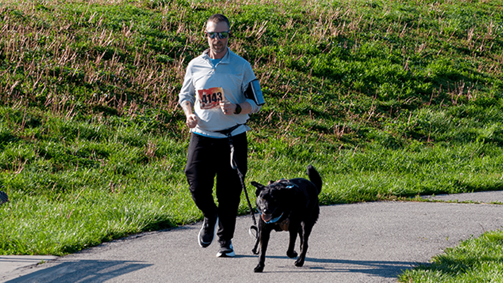 man running with dog