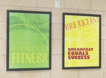 2 poster images in school hallway, healthy message in text, green, yellow, custom signs