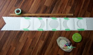 All phases of the moon stenciled on top of table runner fabric.