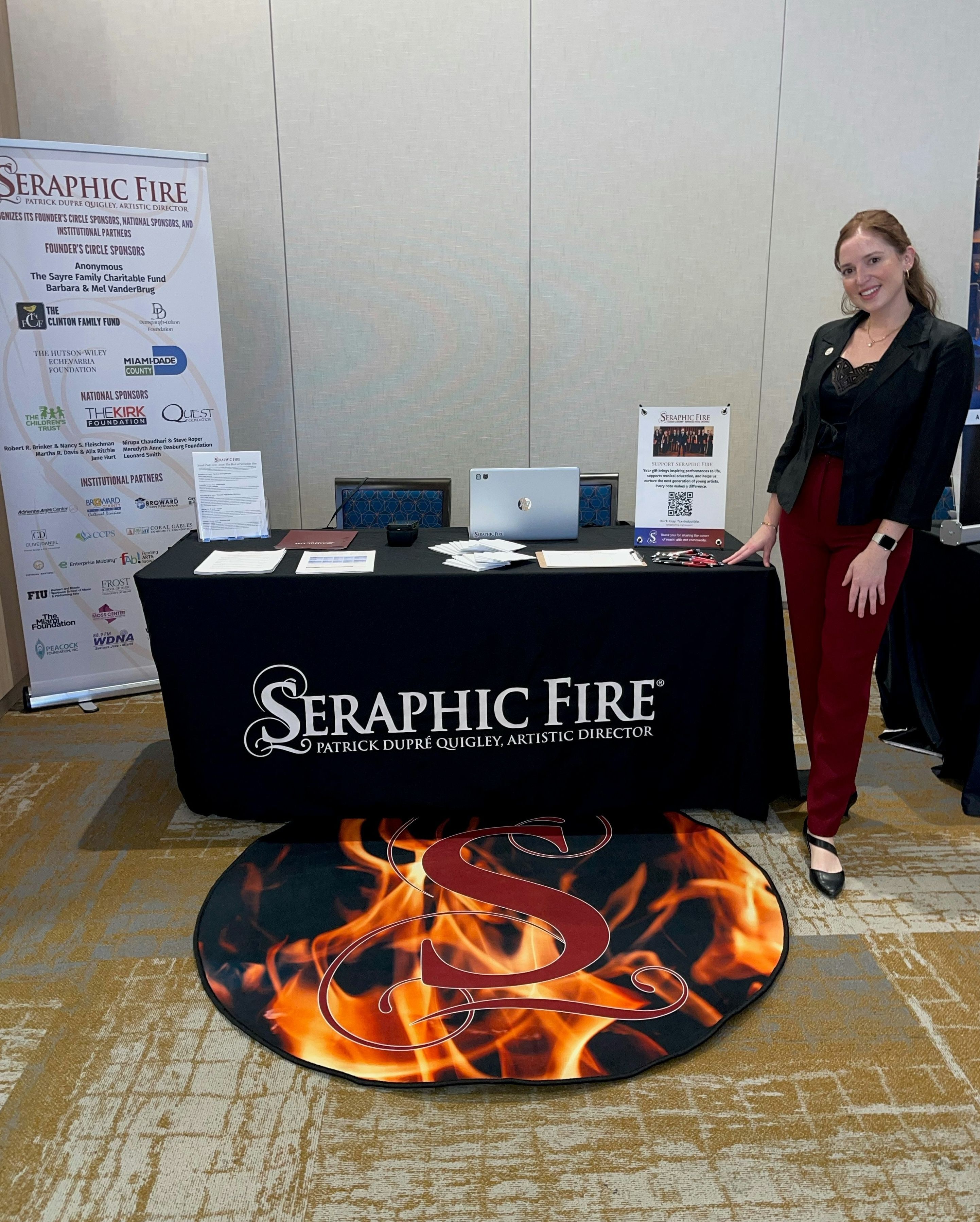 Box Office Associate Sofia Vidali poses next to the Seraphic Fire will-call table.
