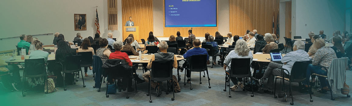 attendees of symposium listening to speaker