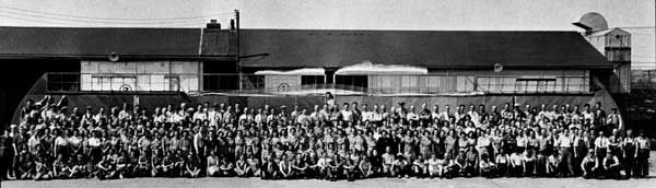 Employees of Dade Brothers of Mineola, NY, gather in front of 100th wing produced