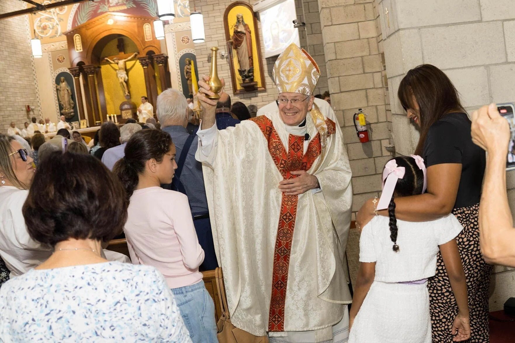 Bishop Gerald M. Barbarito sprinkles holy water in St. Juliana Parishes' renovated church Jan. 10, 2026.