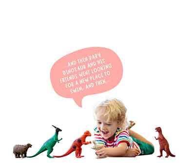 Child playing with dinosaurs and talking to himself - make believe