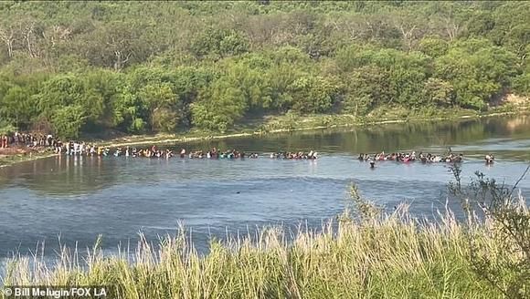 Shocking video shows 'HUNDREDS UPON HUNDREDS' of migrants crossing illegally into the US at the Texas-Mexico border