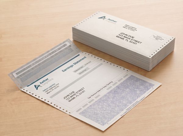 A folded pressure seal earnings statement beside a stack of sealed mailers, showing pressure seal forms used for payroll mailing.