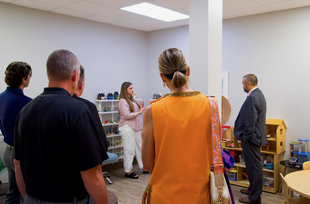 Mwezi demonstrates a play therapy technique for guests during the Media Open House.