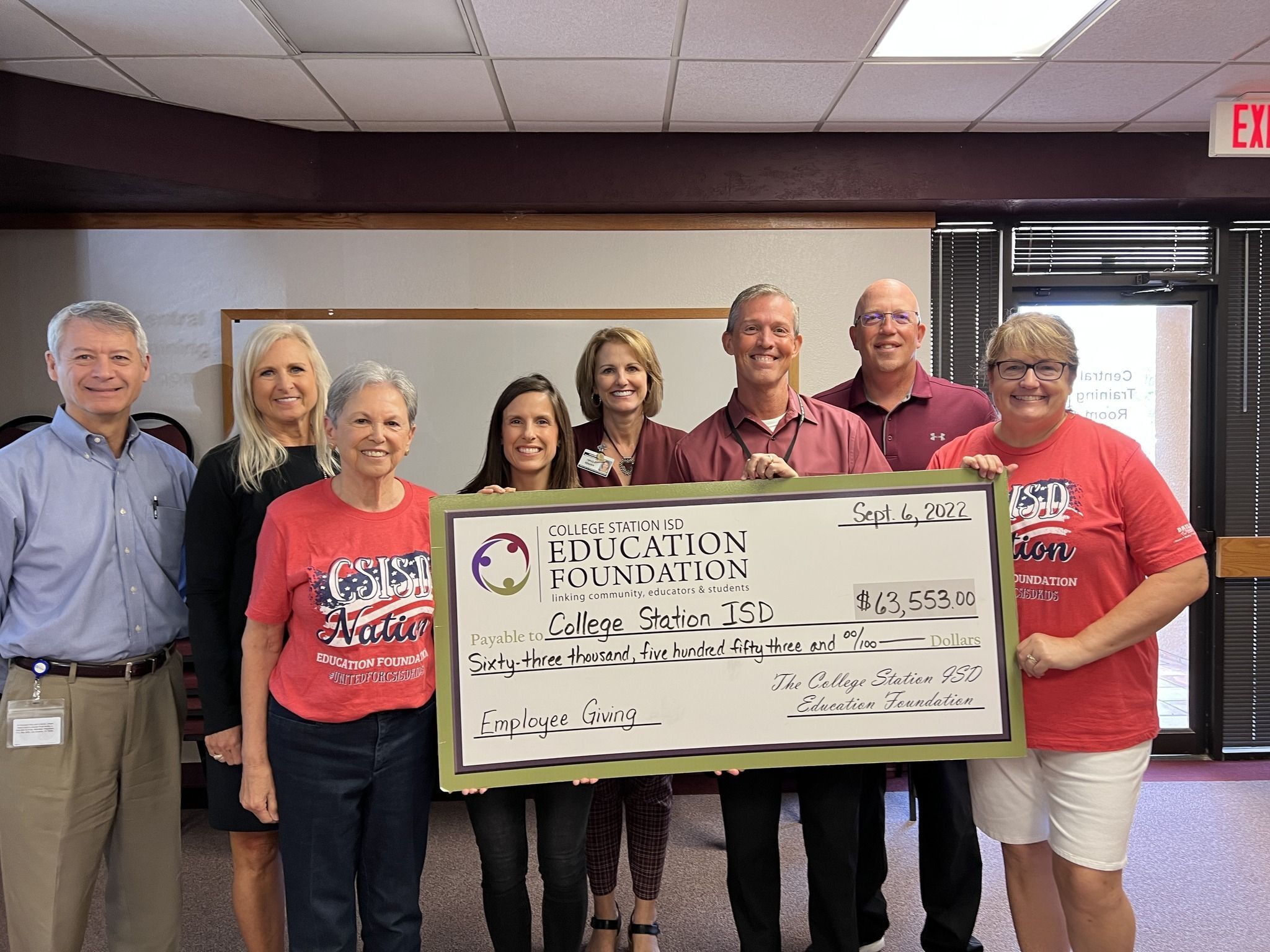 EF Board of Directors presents a check for money raised during the Employee Giving Campaign