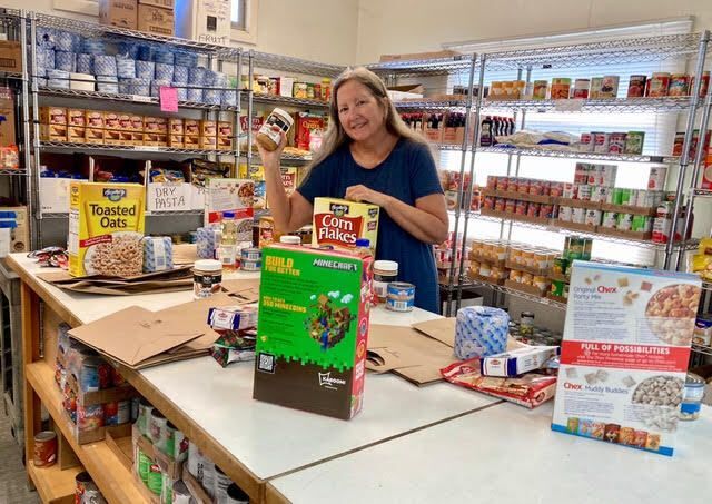 Food Pantry volunteer sorting groceries