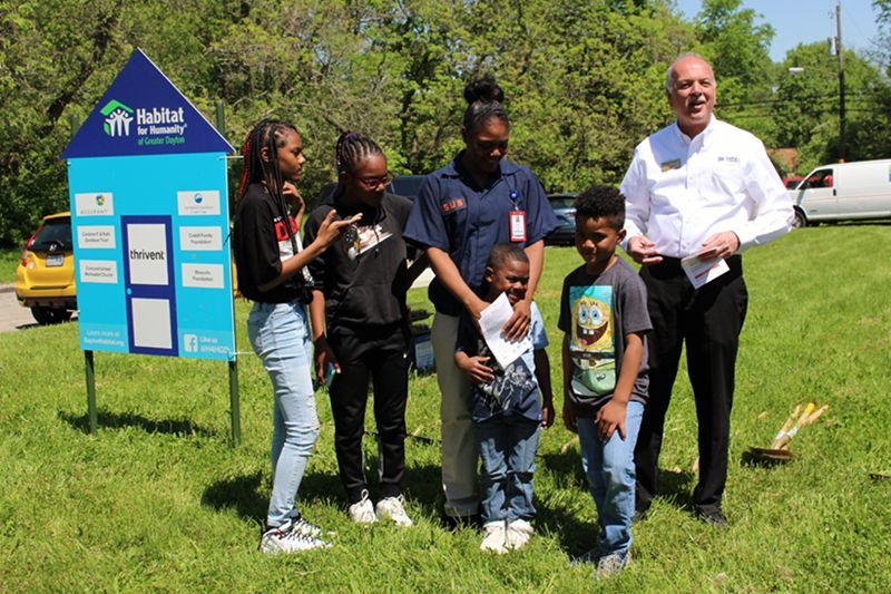 The Wood family pose in front of their building lot in Springfield.