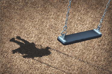 shadow of a child on an empty swing