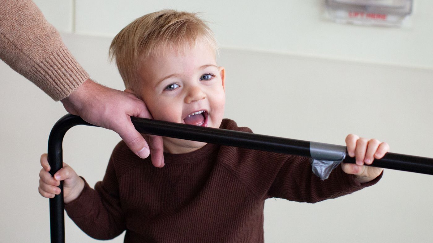 Young boy leaning his face against his dad's hand