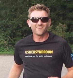 A picture of Collin Eisema wearing a shirt that reads USHERSYNDROOM