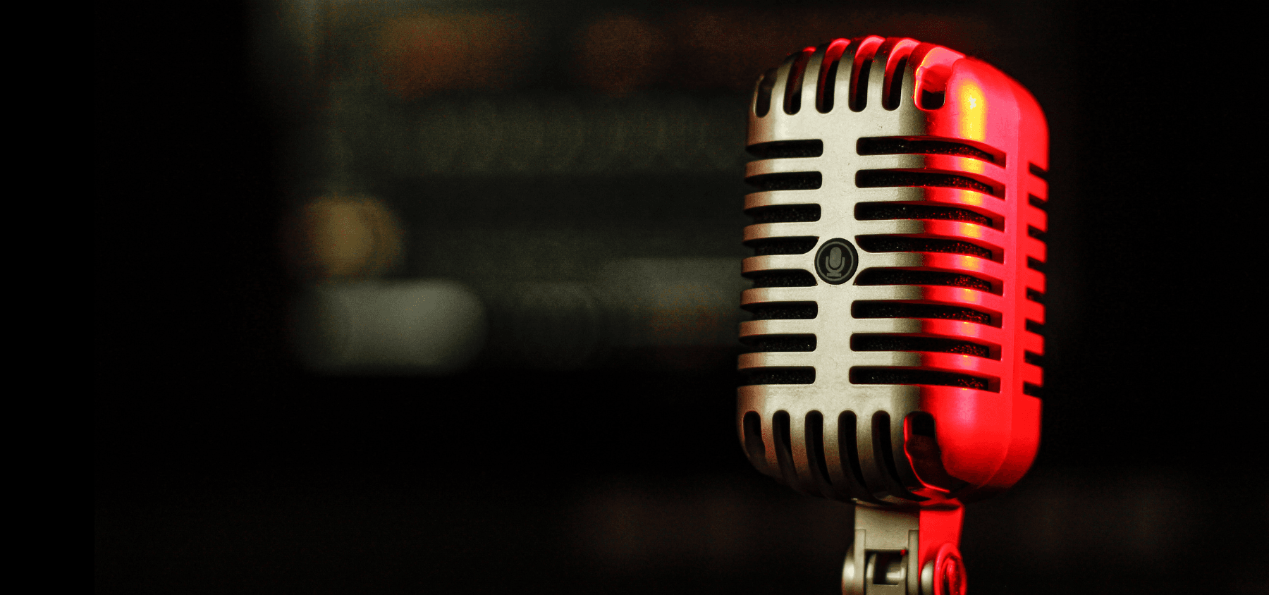 A vintage microphone on a black background.