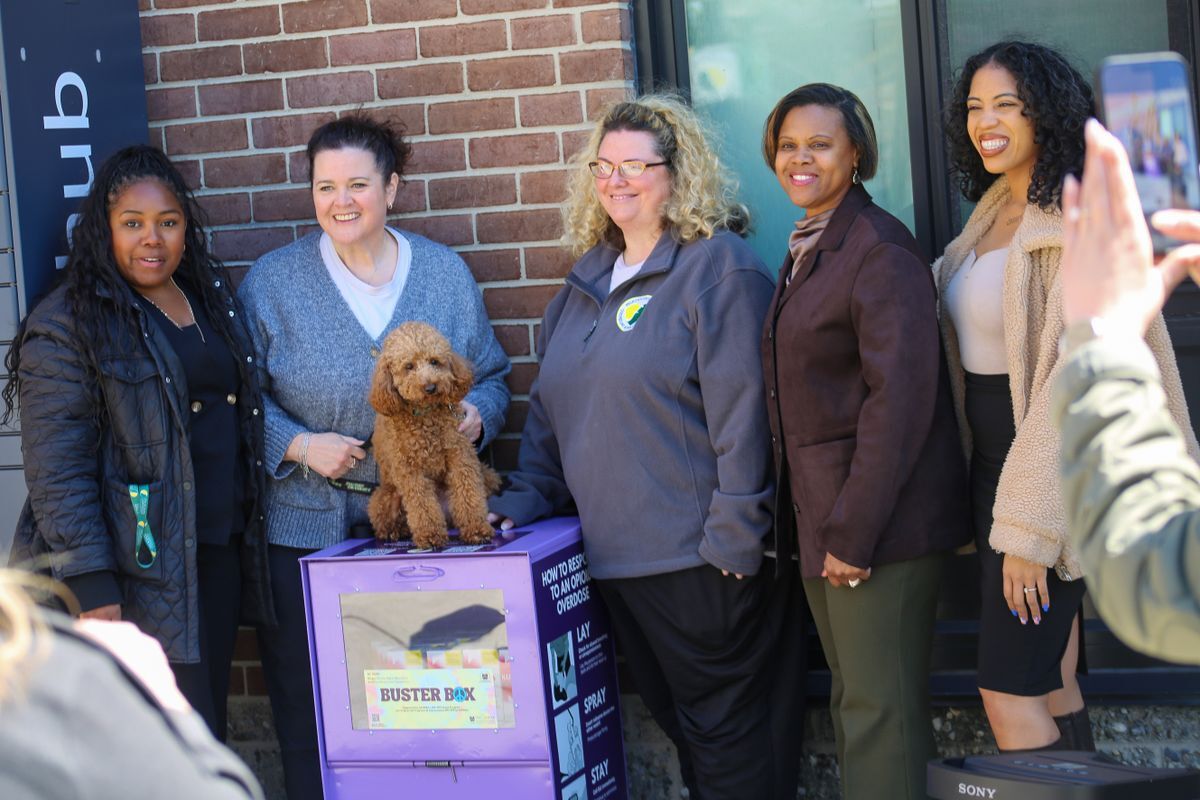 BC HEAP members standing around Felician University's newly installed Buster Box. Felician's therapy dog sits atop the box.