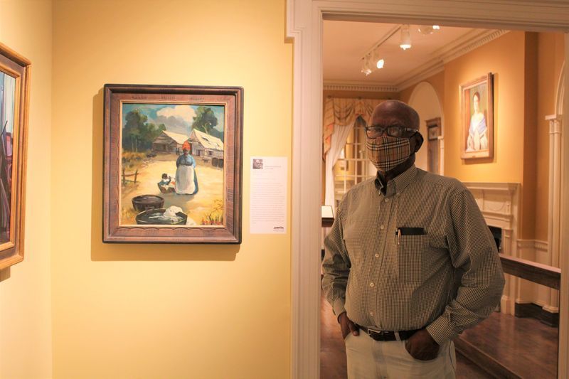 Docent Harry Lindsey stands next to William Edouard Scott's "Wash Day, Alabama," ca. 1930, which was acquired in 2019 by the Alma Thomas Society.