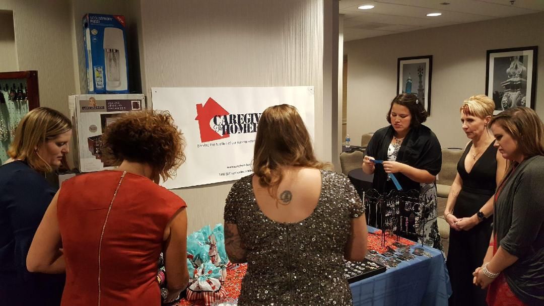 Caregivers selecting jewelry and gift bags at the Wounded Warrior Project Christmas Gala