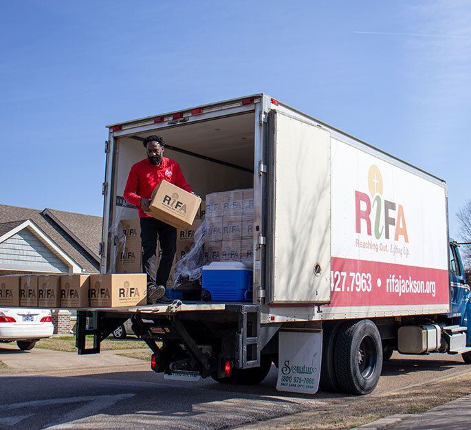 Volunteer unloading a truck.