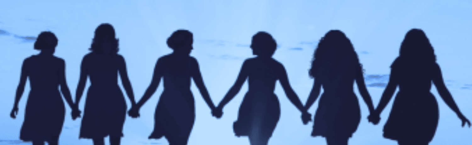 Women walking outside holding hands