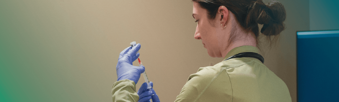 nursing student drawing meds with a syringe