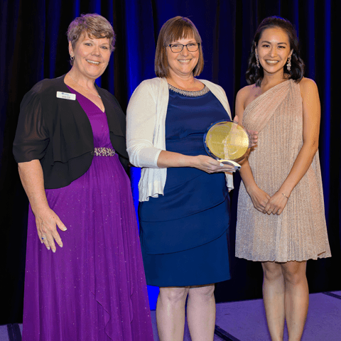 Award winner poses with award at annual gala.