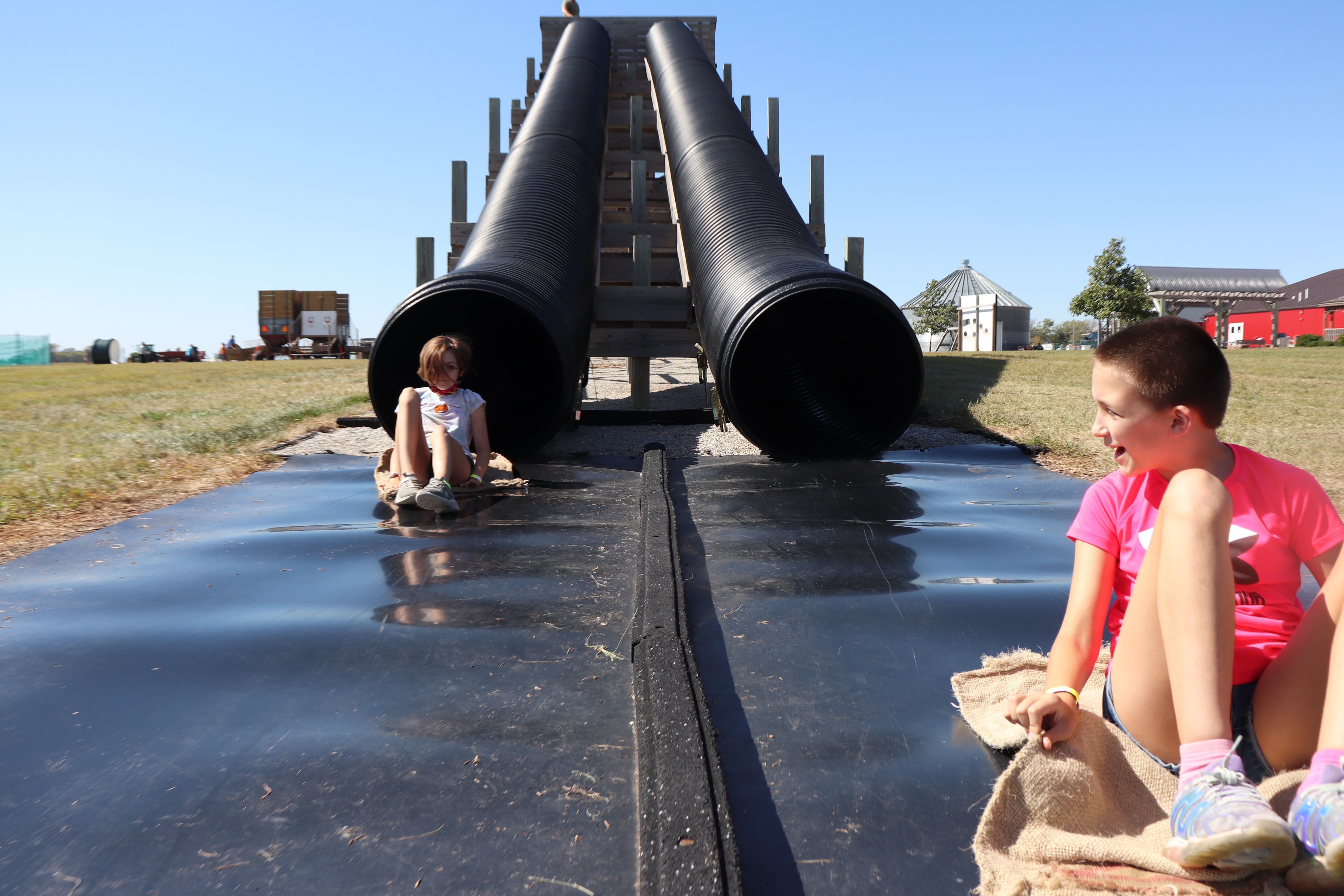 Two children coming out of racing tube slides