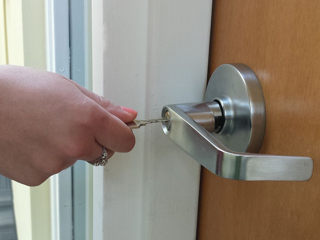 Inserting a key to unlock their front door