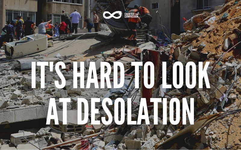 White bold cap words that say: "It's hard to look at desolation" over a photo of people trying to find others in the aftermanth from an earthquake disaster in Turkey and Syria.