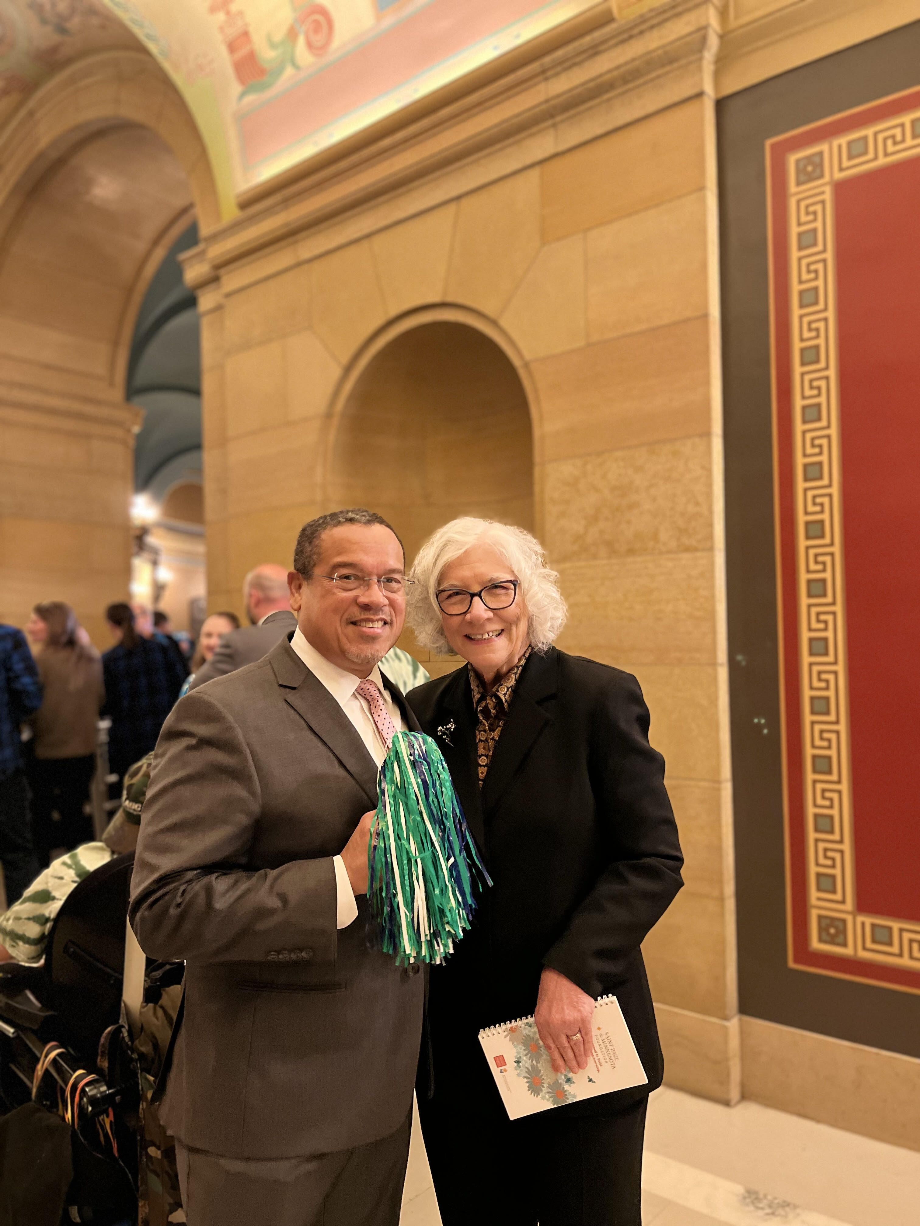 Susan Mackert stands right of Attorney General Keith Ellison at 2025 Disability Services Day at the Capitol