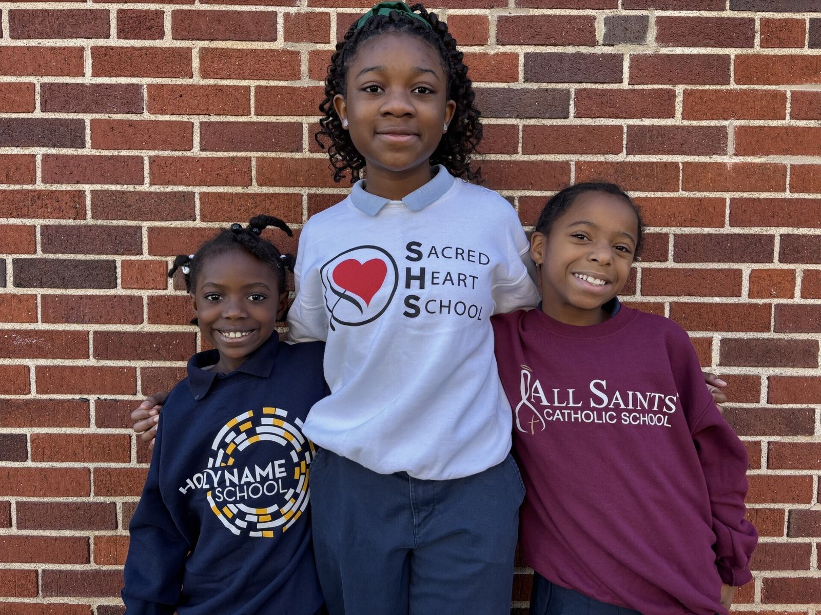 Students wearing shirts from each school