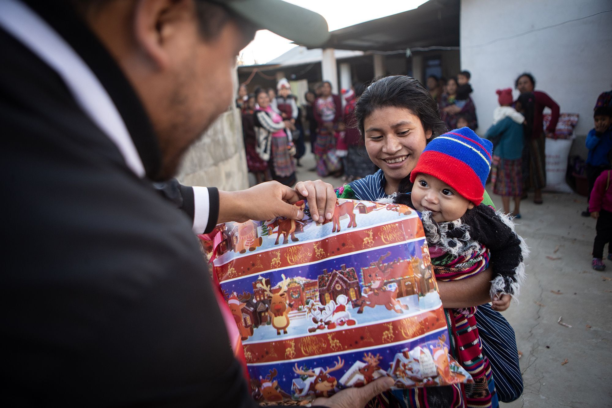 A child receives their Christmas gift from Mission Guatemala.