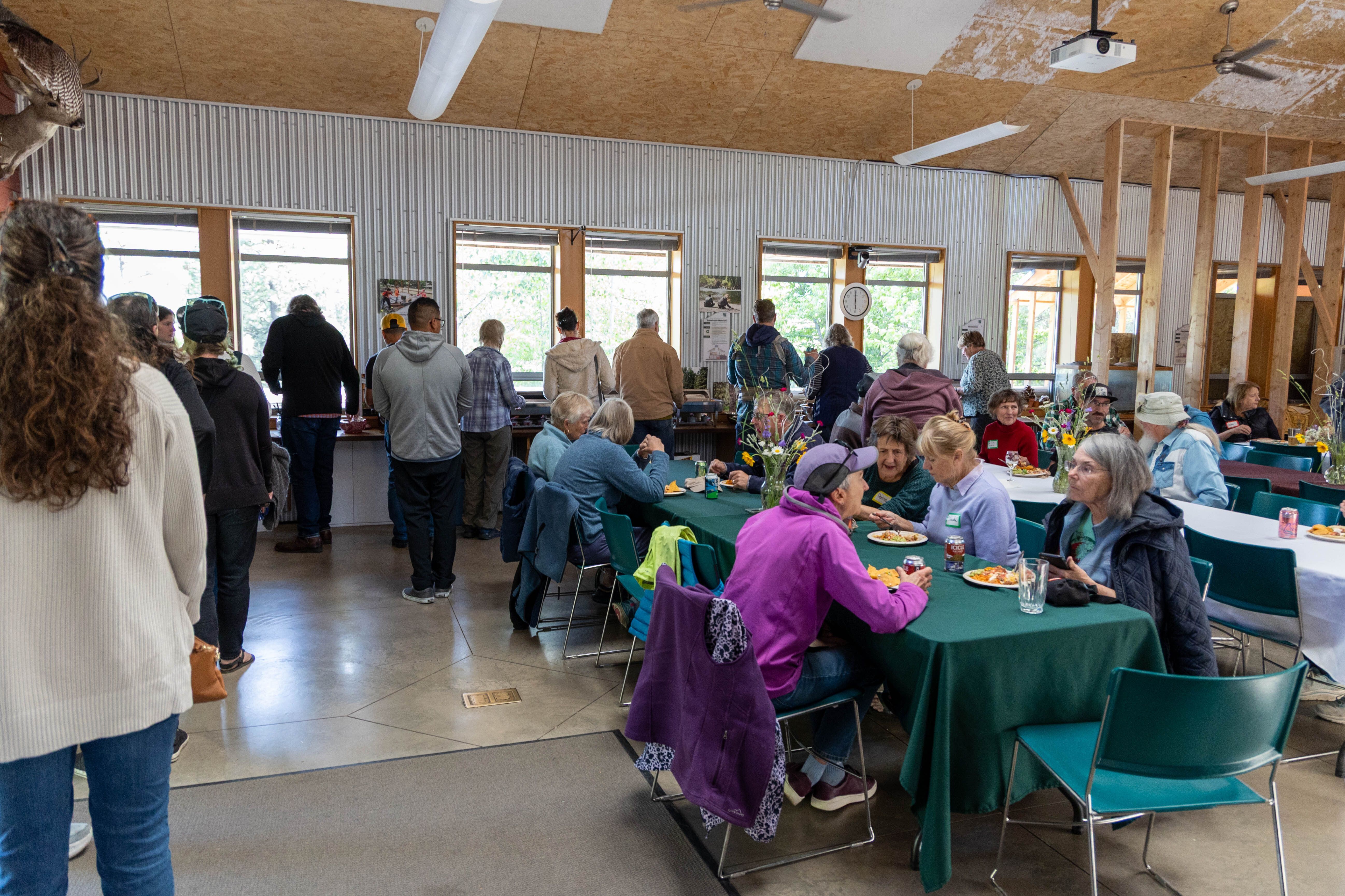 WRI Volunteer Appreciation Dinner 2026 in the Red Barn. Volunteers waiting in line for the El Chavo catered dinner.
