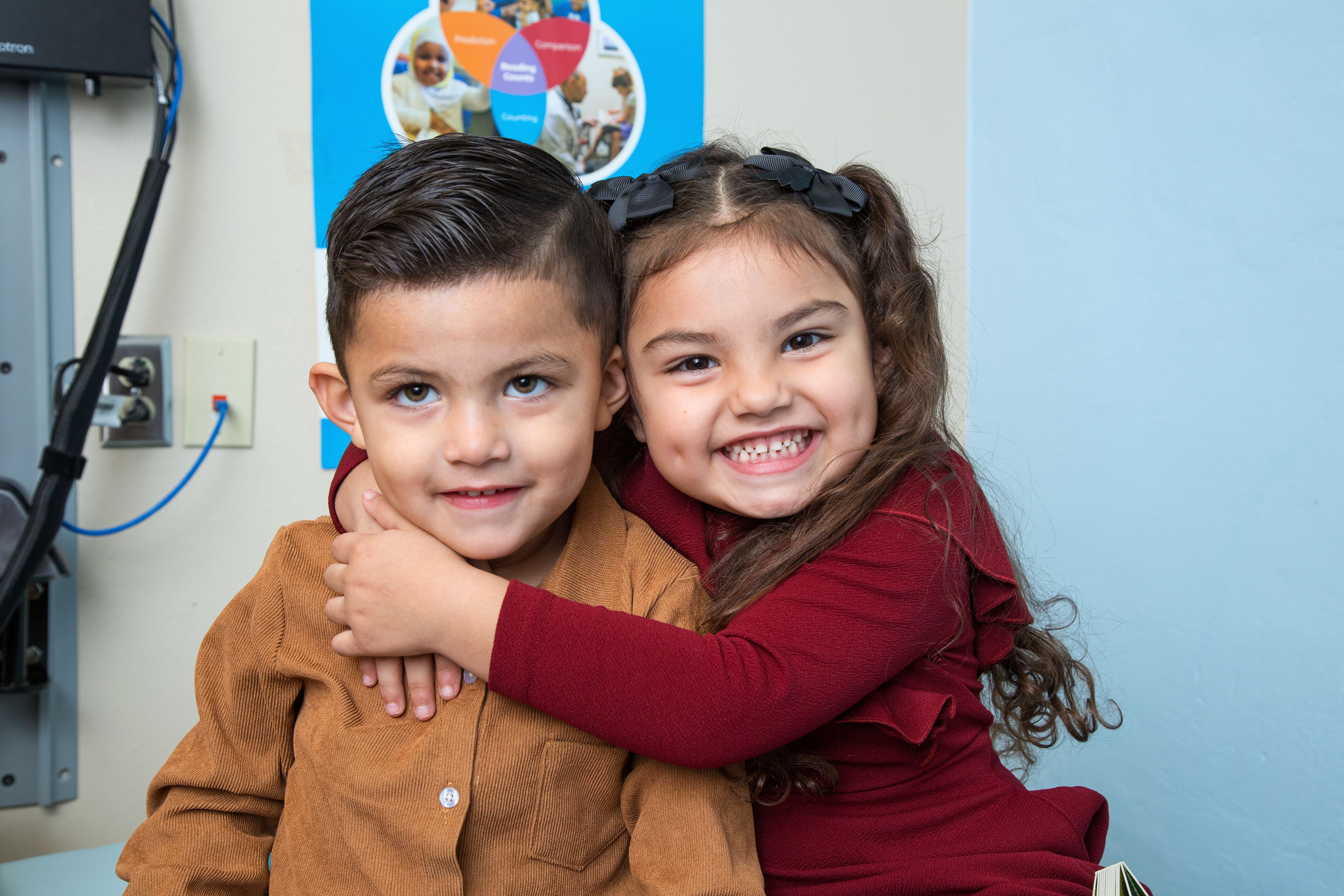 toddler siblings hug