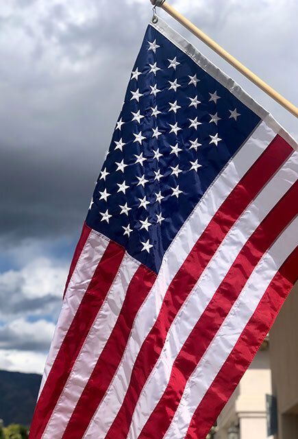 American flag against a cloudy sky.