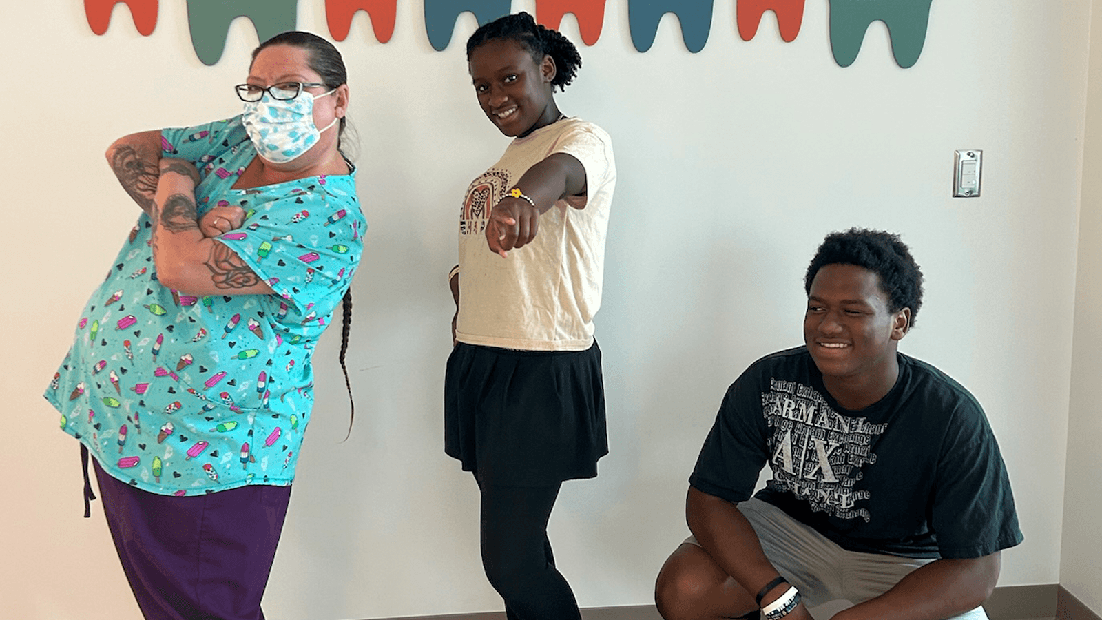 dental assistant and children hitting a boy band pose