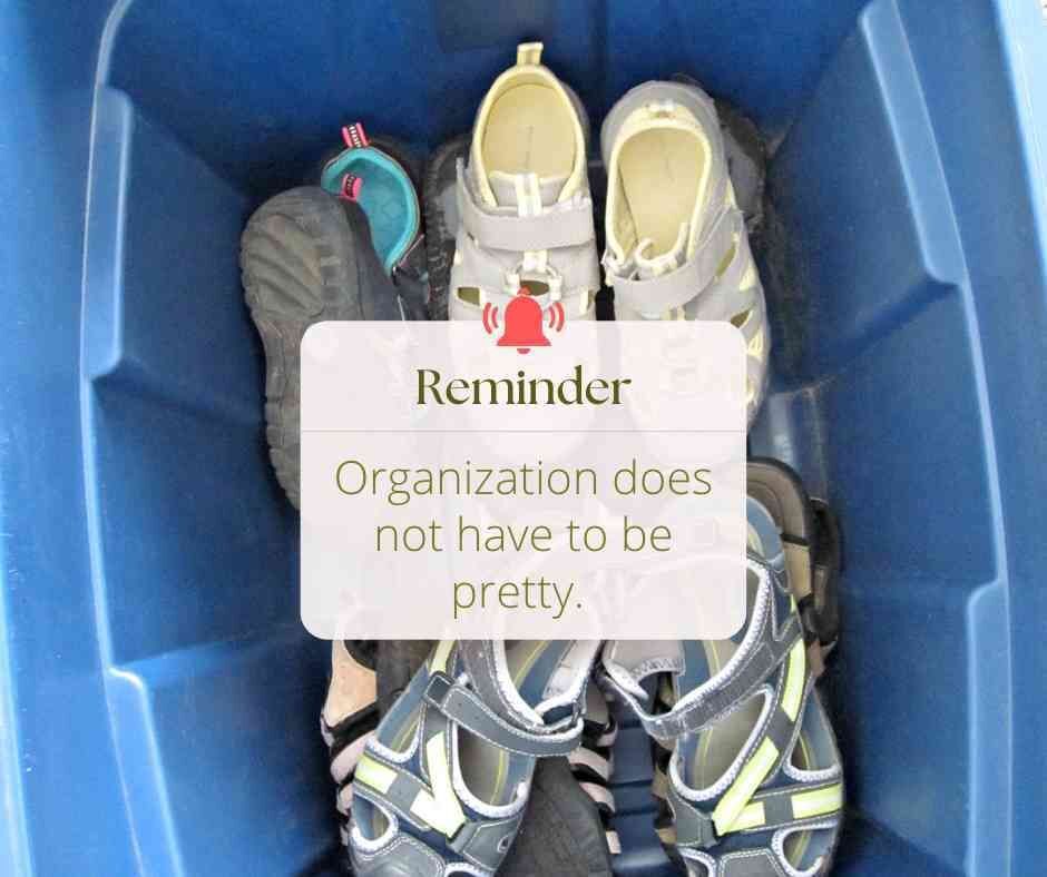 plastic tub full of shoes with reminder "organization does not have to be pretty"