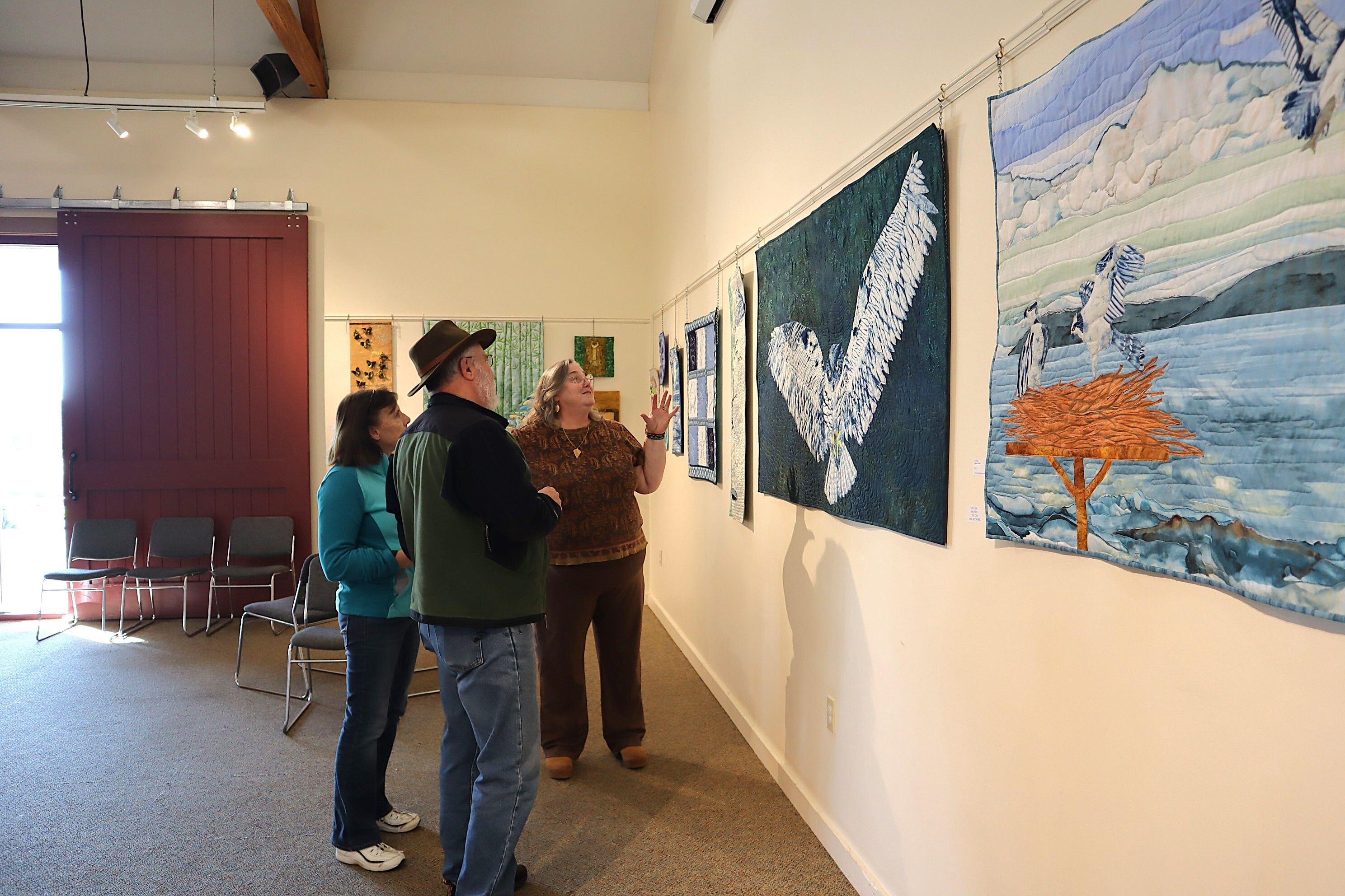 Allison Wilbur with guests at her November & December 2024 quilt exhibit.
