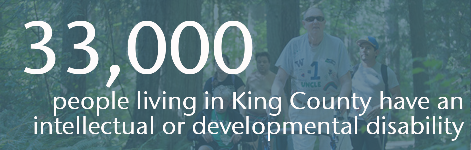 Image of people walking in the woods, with text that reads: 33,000 people in King County have an intellecutal or developmental disability