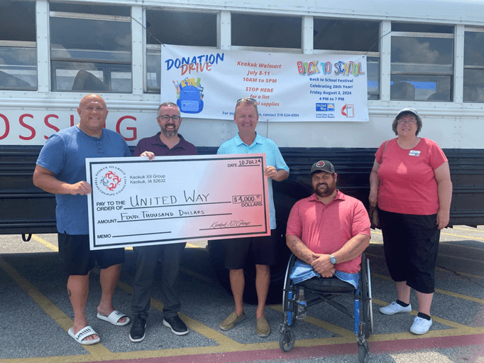 Check presentation for annual Back to School backpack giveaway