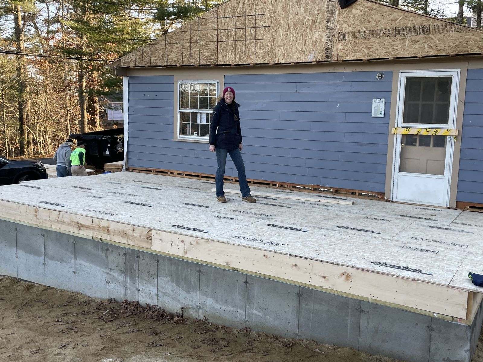 Future homeowner Jacquelyn stands on completed base of new additoon