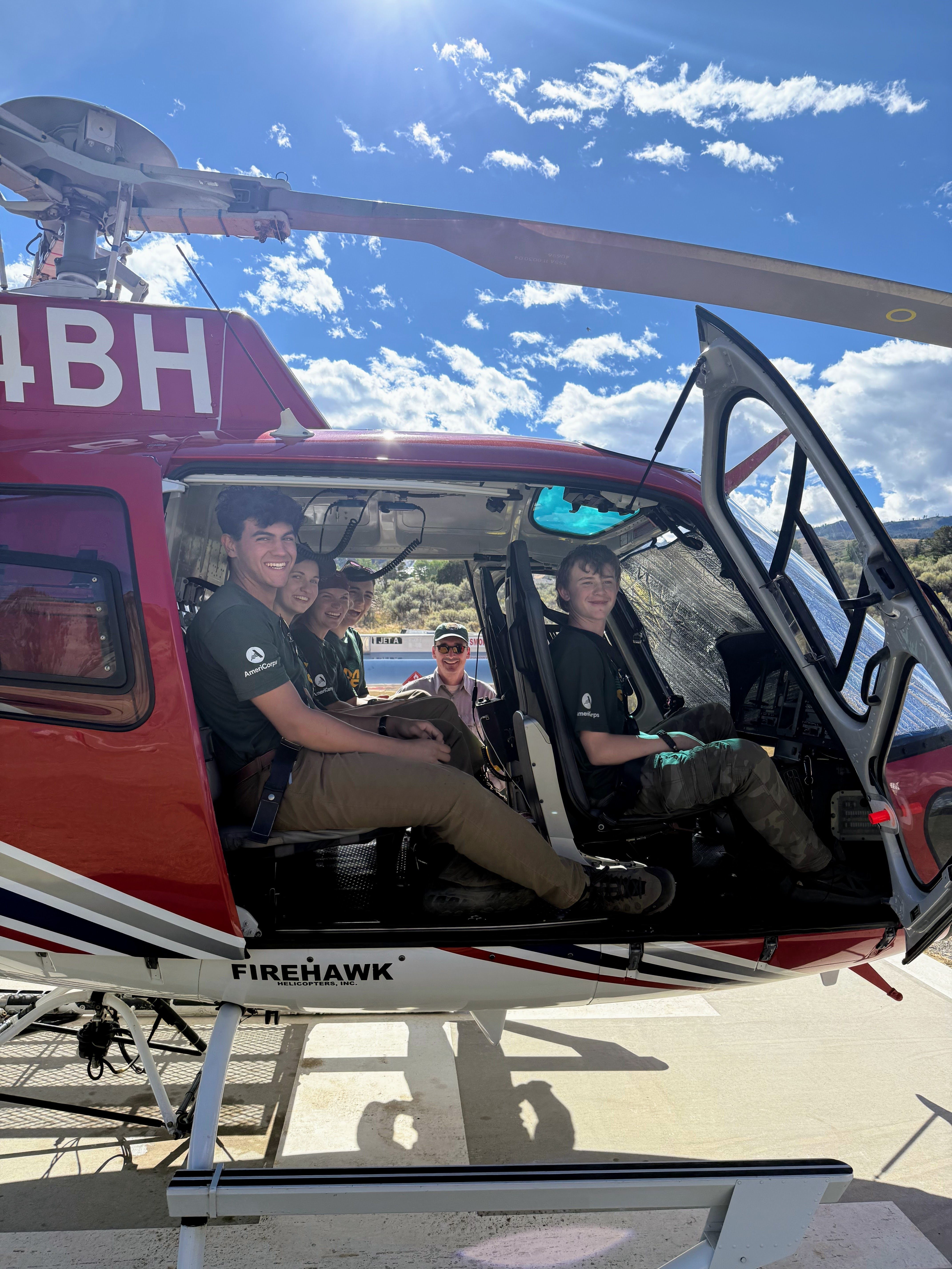 A youth crew sits in a helicopter