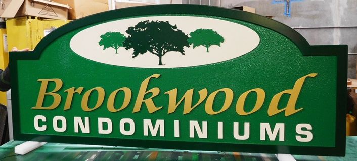 K20331 - Carved HDU Entrance Sign  for the "Brookwood " Condominiums, with  Sandblasted Sandstone Texture Background